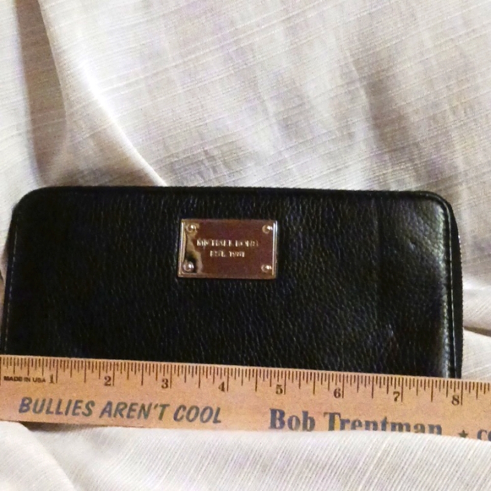 Michael Kors black leather wallet with silver interior.